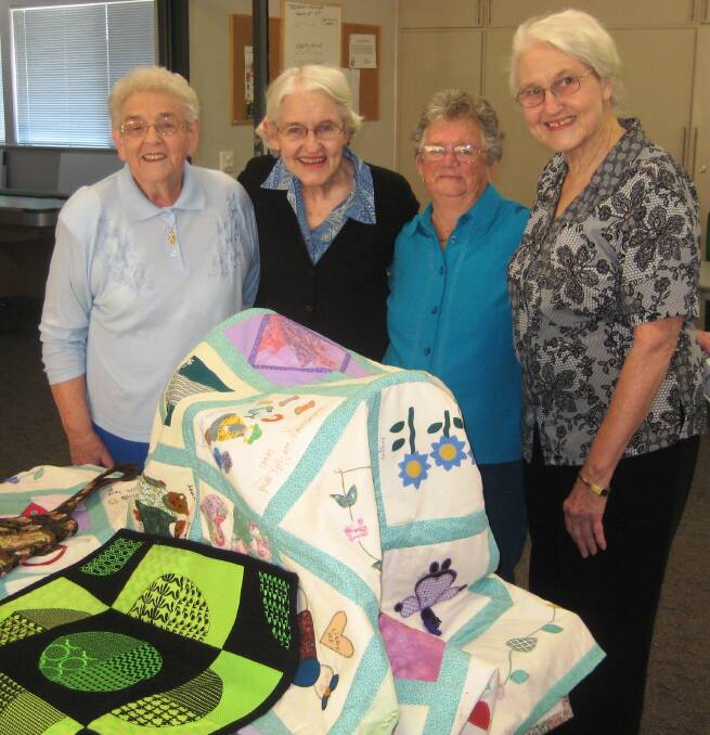 TRADITIONAL: Anglican Care Auxiliary members Betty Bowditch, Margaret Clark, Pat O'Reilly and Audrey Clark prepare for the annual Art and Craft Exhibition and Sale.