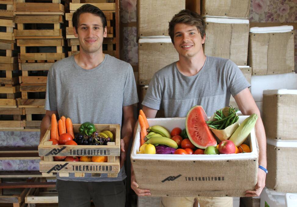BOXES OF HEALTH: The Fruit Fund creators Daniel Lee and John Hodge with boxes of produce to deliver.