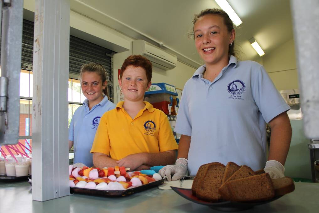 CANTEEN WORKERS: Belmont Public School year 6 students Cassie McLennan, Harry Bartlett and Emily May serve it up at the Snack Shack.