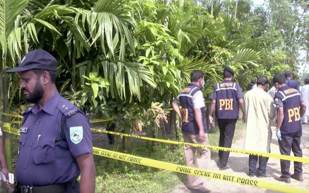 Investigators work at the site in northern Bangladesh where Kunio Hoshi, 50, was killed by two masked men.