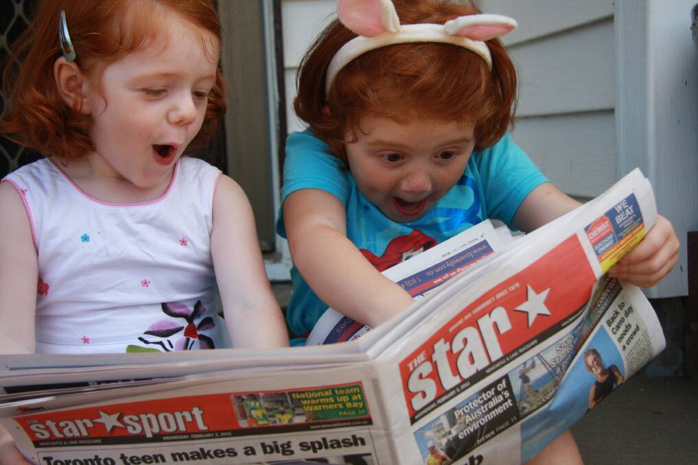 IN THE NEWS: Heather Peacock's winning photograph of these avid Star readers was taken at home.