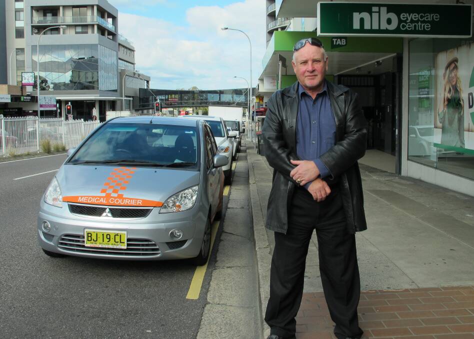 CALL TO ACT: Business Charlestown vice president John Wheeler stands outside his business, Bank of Queensland, on the Pacific Highway, Charlestown.