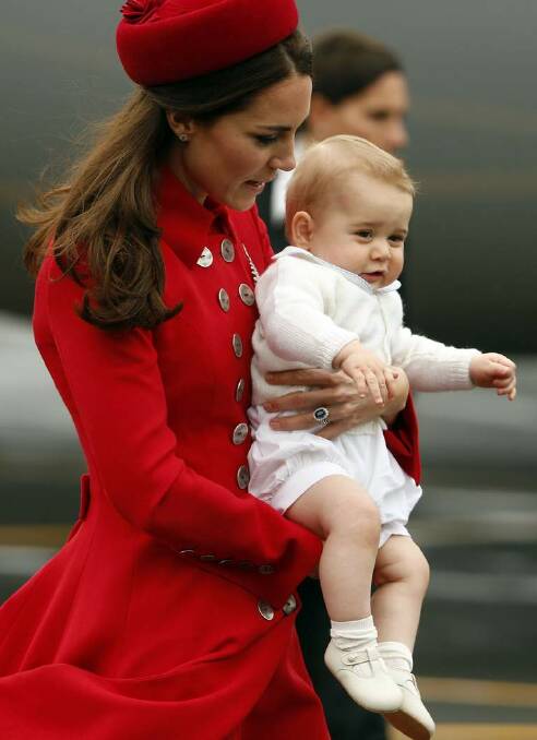 Catherine, the Duchess of Cambridge, holds her son Prince George after disembarking their plane with her husband Britain's Prince William in Wellington April 7, 2014.