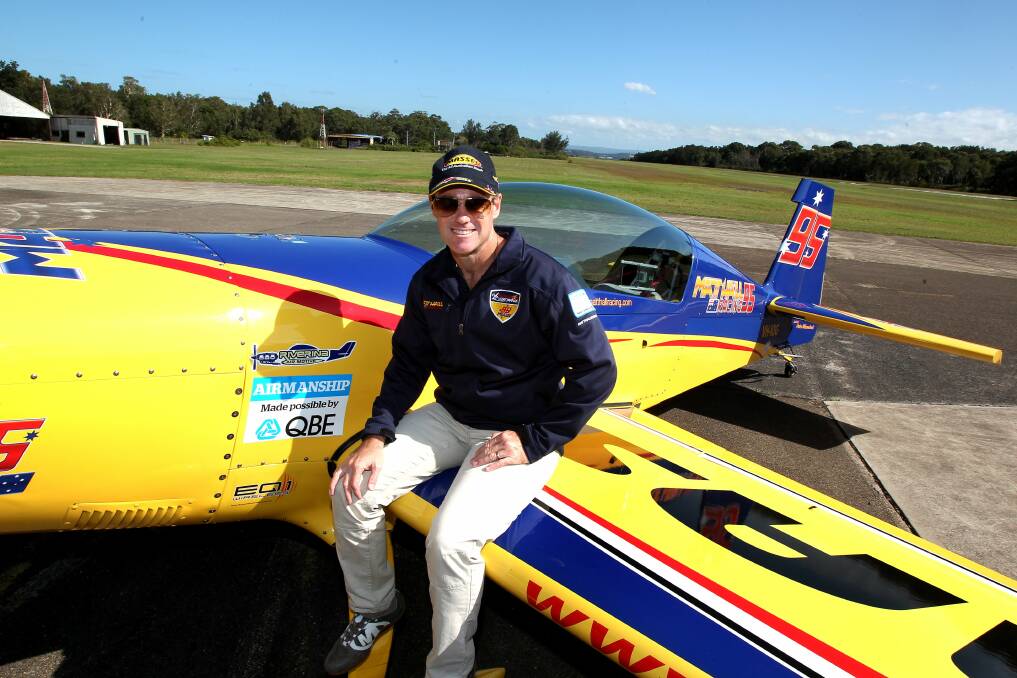 AIMING HIGH: Red Bull air race pilot and Belmont Airport co-owner Matt Hall at the airstrip with one of his planes.