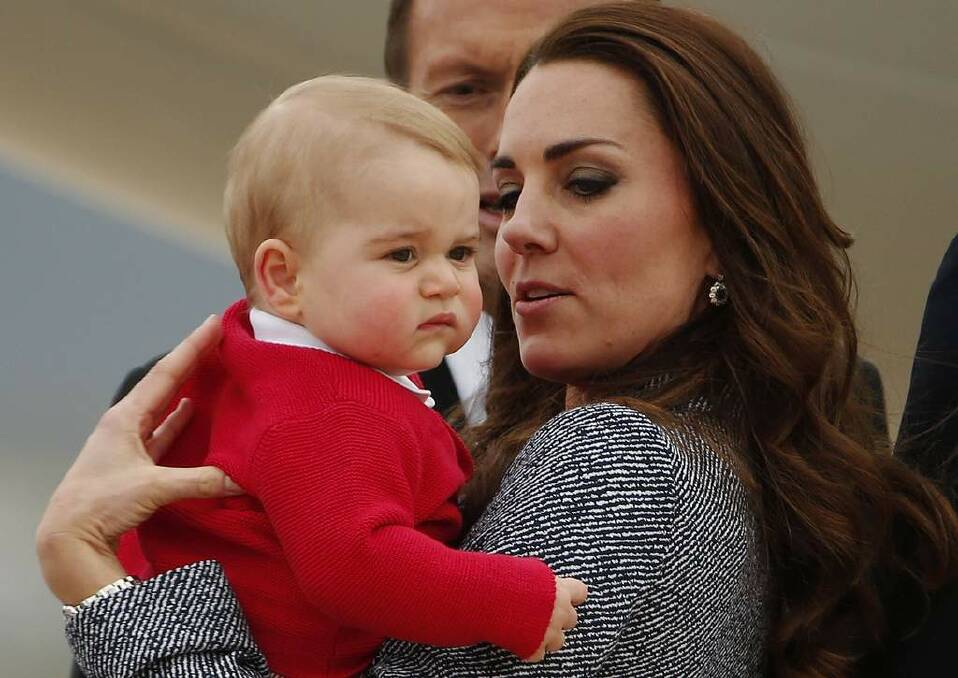 Britain's Catherine, the Duchess of Cambridge, holds her son Prince George as they prepare to board a plane with her husband Prince William (not pictured) to depart Canberra April 25, 2014. Photo: Phil Noble