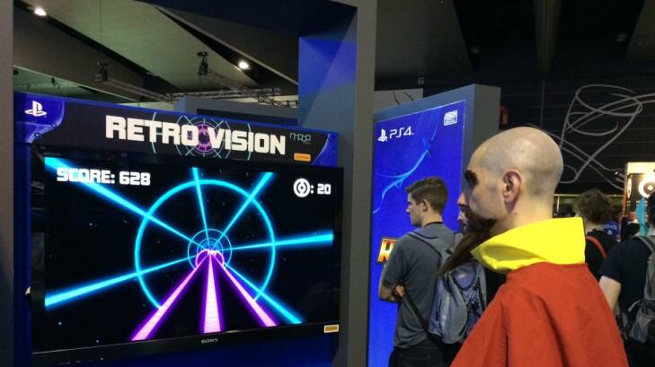 A PAX Australia attendee plays Retro Vision, one of four student-made games coming to PlayStation 4. Photo: Kyle McKellar