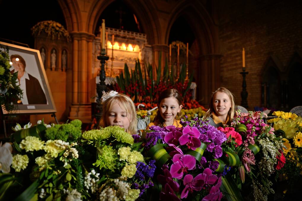 FEAST OF COLOUR: Alex Miles, 7, Asha Osborne, 10, and Emily Miles, 10, admire the floral displays in Newcastle’s Christ Church Cathedral last year. 