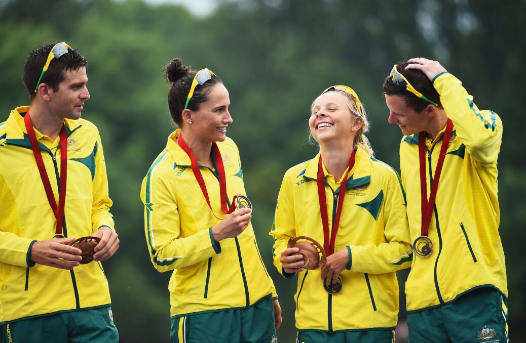 Bronze medalists Aaron Royle, Emma Moffatt, Emma Jackson and Ryan Bailie of Australia celebrate on the podium during the medal ceremony for the Triathlon Mixed Team's Relay.  Photo: Getty Images.