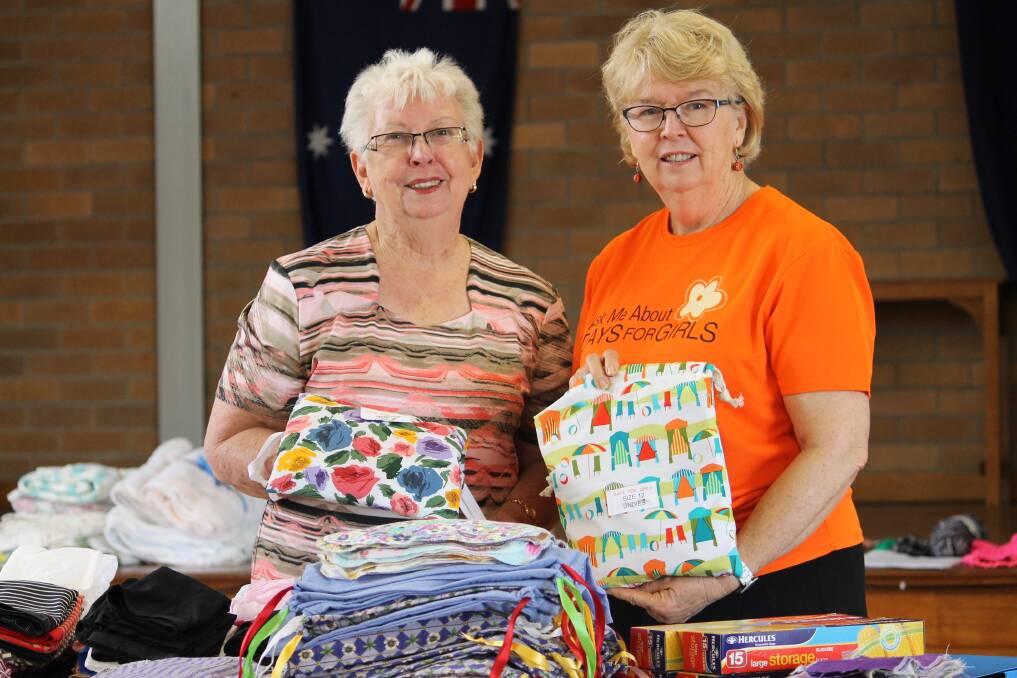 NEW OUTLOOK: CWA NSW Belmont branch president Maureen Drinkwater and Days For Girls Australia co-ordinator Gloria Buttsworth with some of the donated kits.