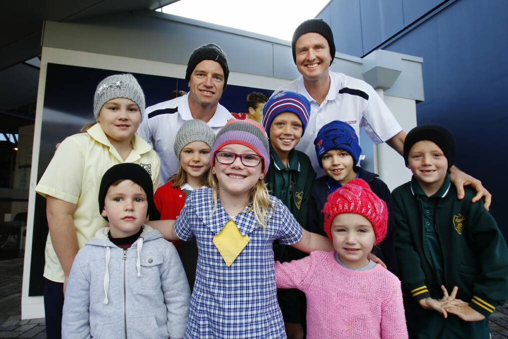 BRIGHT IDEA: Brain cancer awareness advocate Mark Hughes (back right) and Newcastle Knights' Danny Buderus (back left) with school kids (front row, from left) Lachie Buderus, Addison Macdonald, Bonnie Hughes, (middle row) Sienna Macdonald, Ella Buderus, Zac Hughes, Ethan Martin, and Dane Hughes.