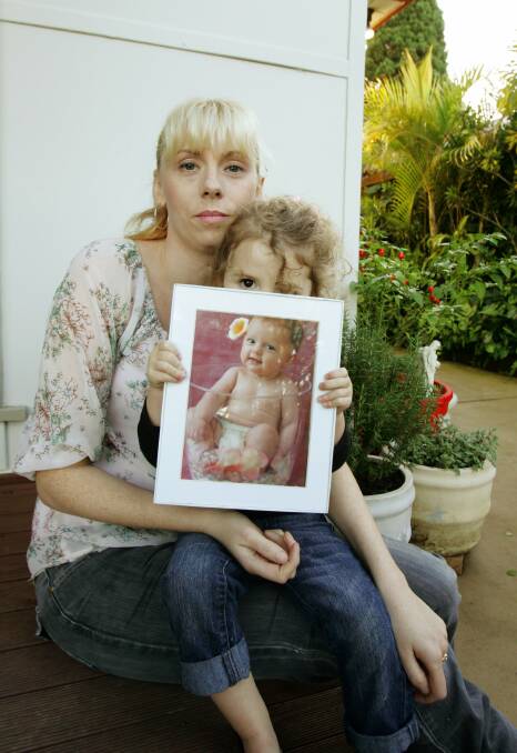 Rachael Blaxell with her daughter Evangeline, 2, and a photo of Lilli at four months.