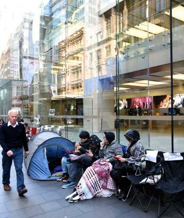 Tent city: iPhone fans (and those working as place holders) outside Apple's Sydney store in George St on Friday morning. Photo: Steven Siewert