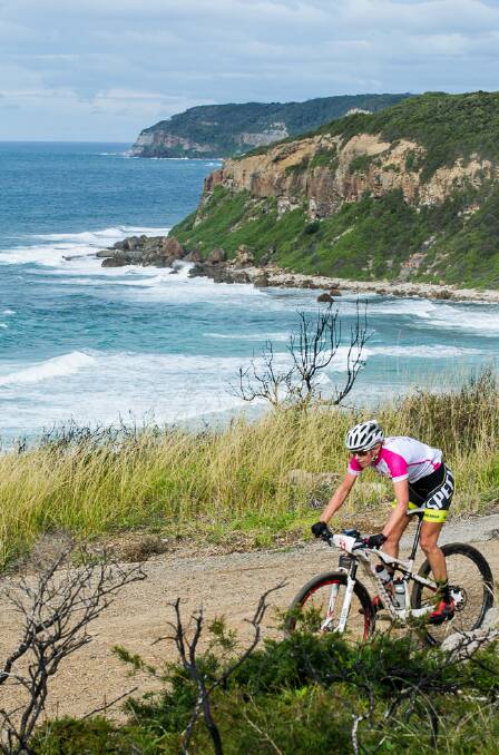 PEDAL POWER: Jenny Fay, women's race winner of the 2014 inaugural Port to Port MTB, rides along the Newcastle coastline. Picture: Gilbert Romane