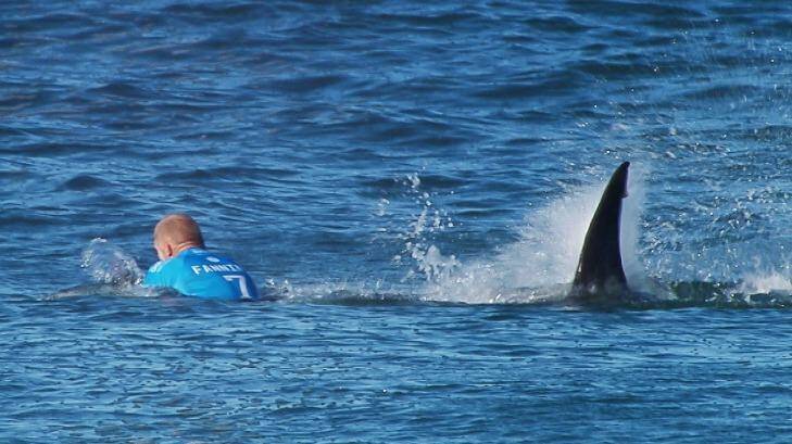 The moment a huge shark launches at Australian surfer Mick Fanning, who escaped without injury after he "punched him in the back".  Photo: WSL