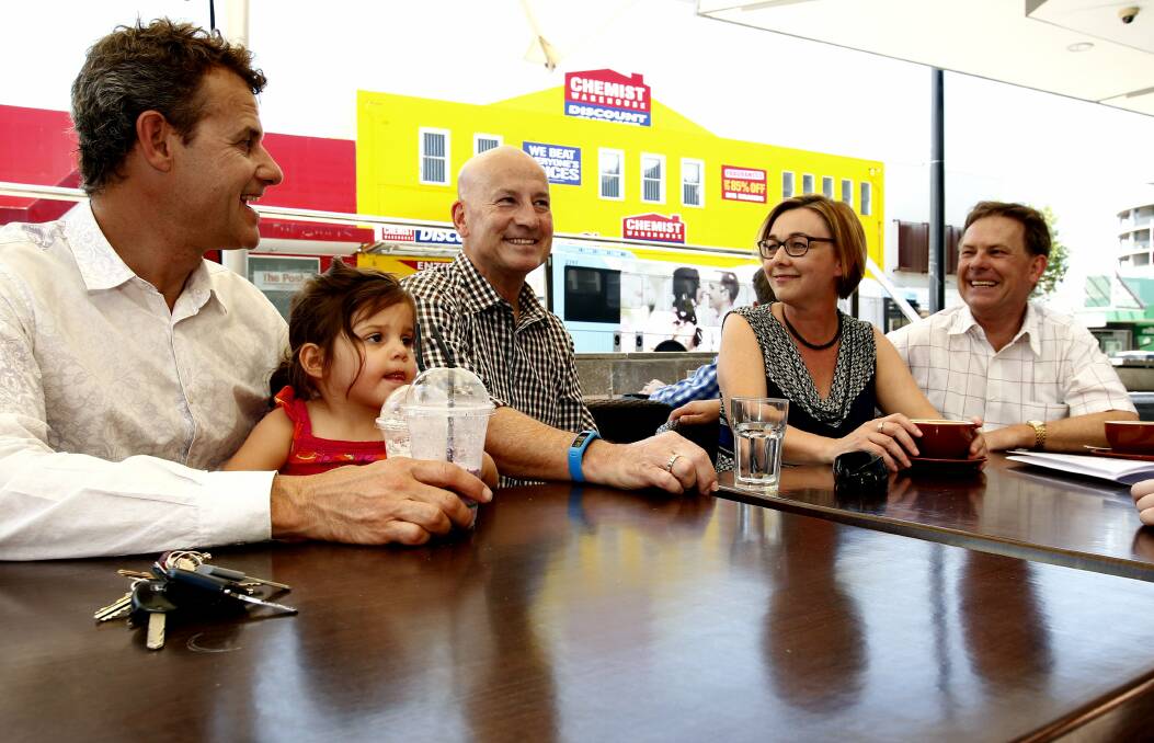 WINNERS: Tim Crakanthorp (successful in Newcastle) with his daughter Avalon, NSW Opposition Leader John Robertson, and the triumphant Jodie Harrison with her husband Bruce.