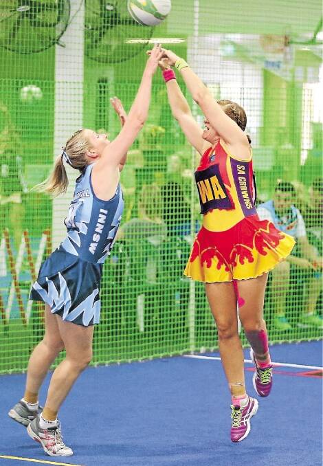 Wallsend netballer Emma Dumbrill (left) competing in last year‚Äôs Indoor Netball Nationals against the South Australian Crowns.