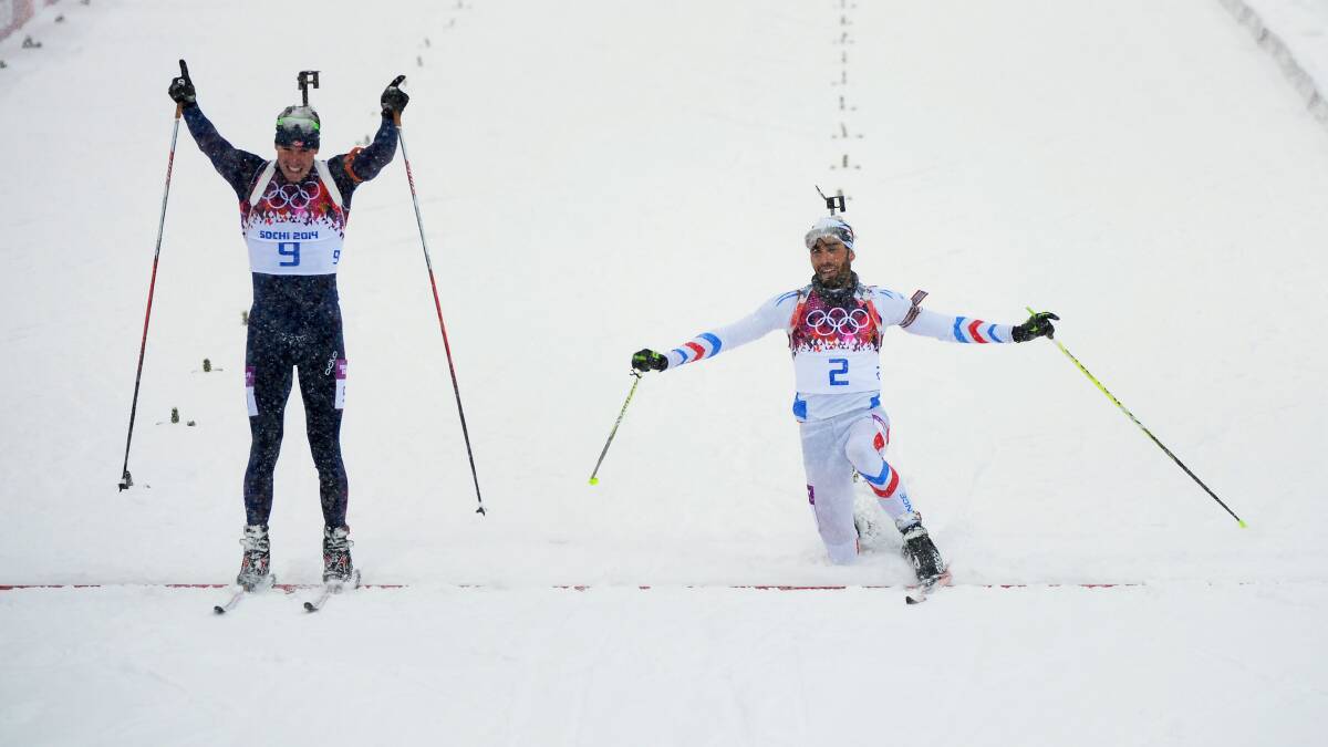 Martin Fourcade of France stretches for the finish line next to Emil Hegle Svendsen of Norway during the Men's 15 km Mass Start during day 11 of the Sochi 2014 Winter Olympics at Laura Cross-country Ski & Biathlon Center on February 18, 2014 in Sochi, Russia. Photo: GETTY IMAGES