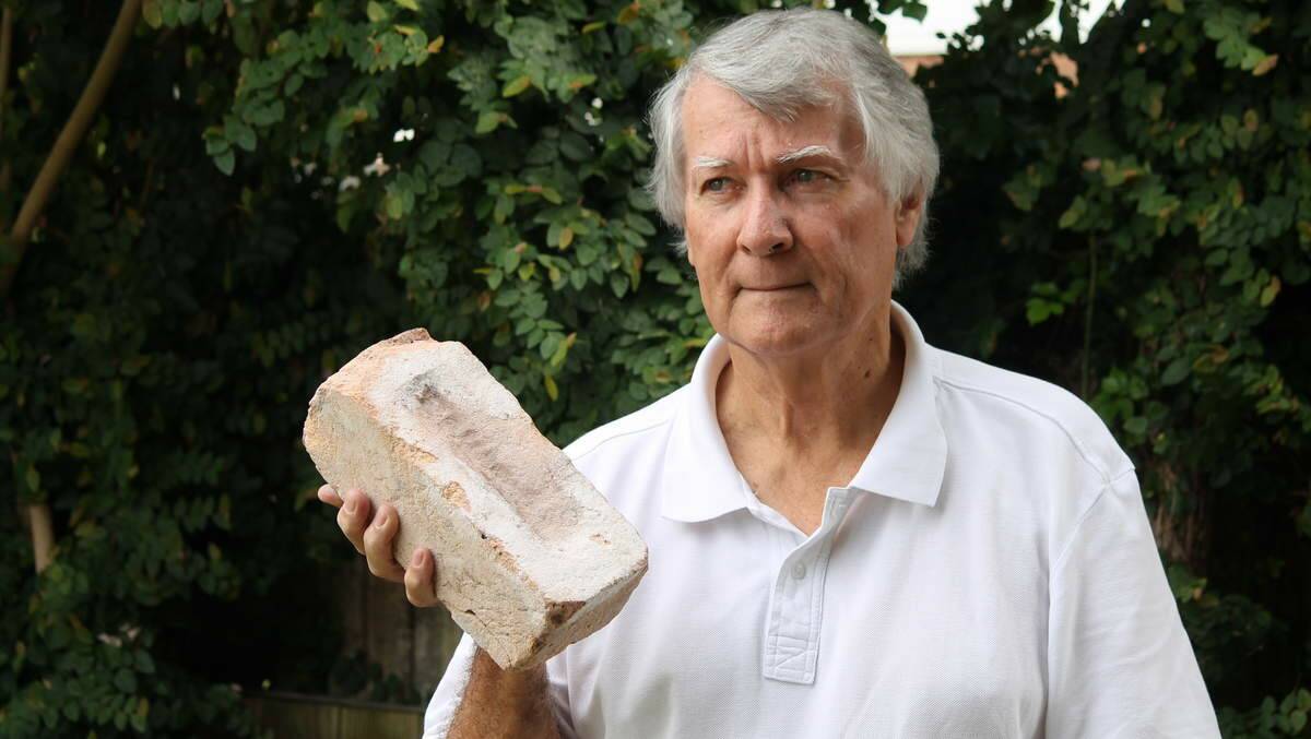 New Lambton’s Stewart Osland holds a brick recovered from a Union Street building that collapsed in the 1989 earthquake.