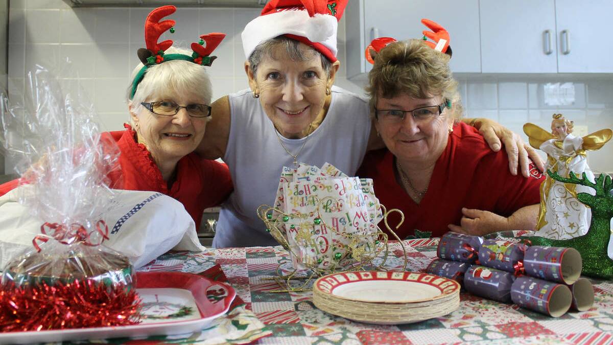 LUNCH LADIES: All Saints Anglican Church Belmont volunteers Deirdre Hughes, Helen Edwards and Sandy Boyd prepare for the church’s annual Christmas Day luncheon.