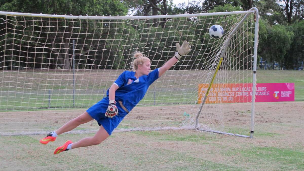 WORKER: Newcastle Jets W-League goalie Hannah Southwell dives for the ball during training at Adamstown No.1 Oval.