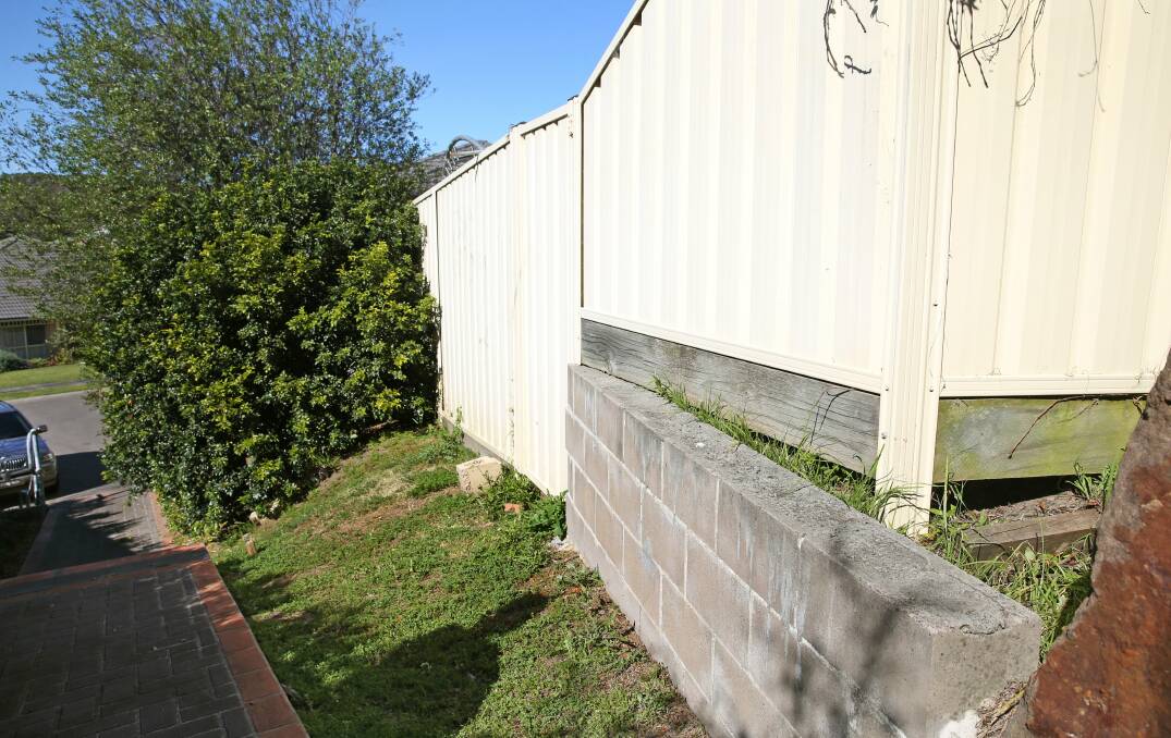 The rear fence and communal footpath near where the girl was attacked at Valentine.