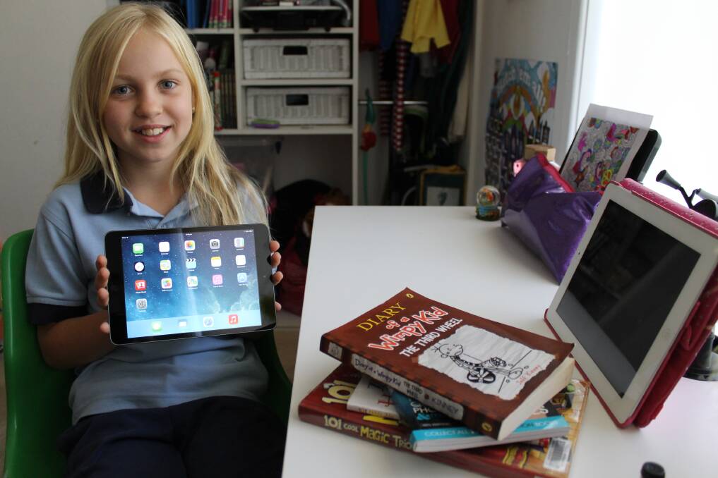 PRIZE: Swansea's Paige Allen with the iPad mini she won for her participation in the Summer Reading Program.