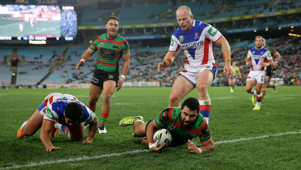 The Newcastle Knights clamber to stop South Sydney Rabbitohs’ Alex Johnston scoring a try.