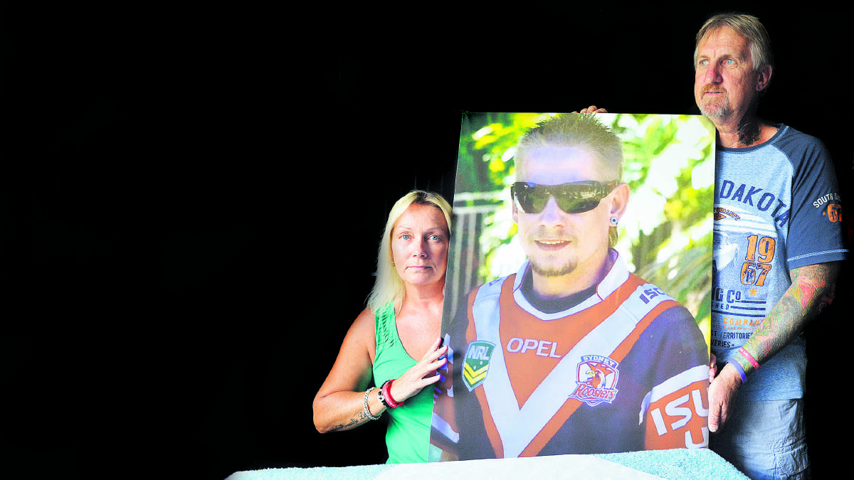 FUNDRAISER:  Donna and Paul Stevens with a picture of Steven in his beloved Roosters jumper.	 Picture by STUART SCOTT 