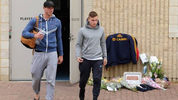 Toughest of days: Daniel Talia and Rory Laird leave the Adelaide club rooms as tributes are left for coach Phil Walsh. Photo: Getty Images