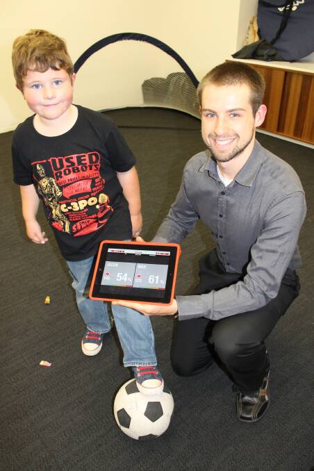Max Clarke, aged 5, from Adamstown, with the University of Newcastle's Priority Research Centre’s Jaegger Olden.