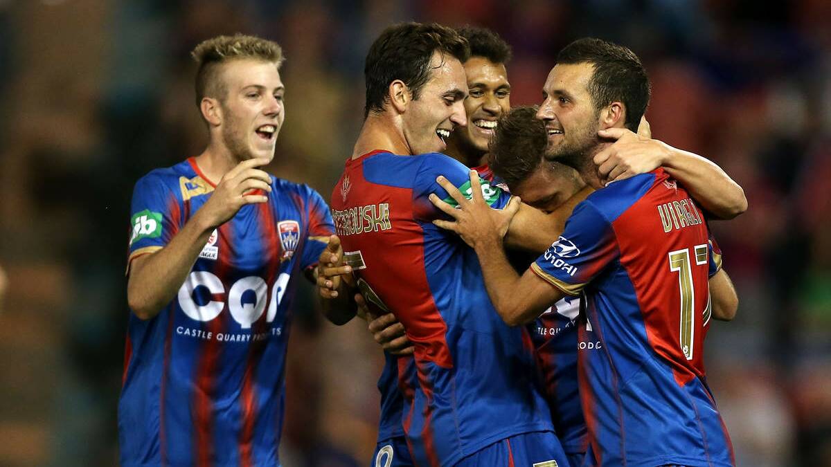 Jets players celebrate a goal against Adelaide United at Hunter Stadium on December 19. 