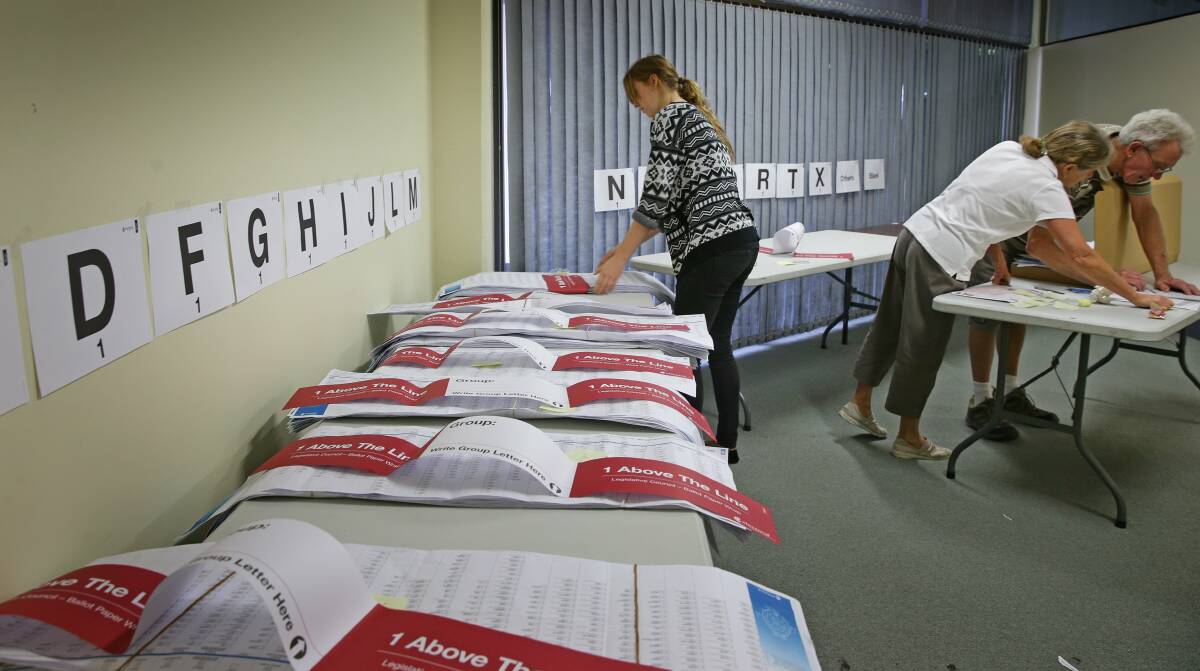 Votes are counted at the electoral office on Darby Street in Newcastle. Pictures: Marina Neil  
