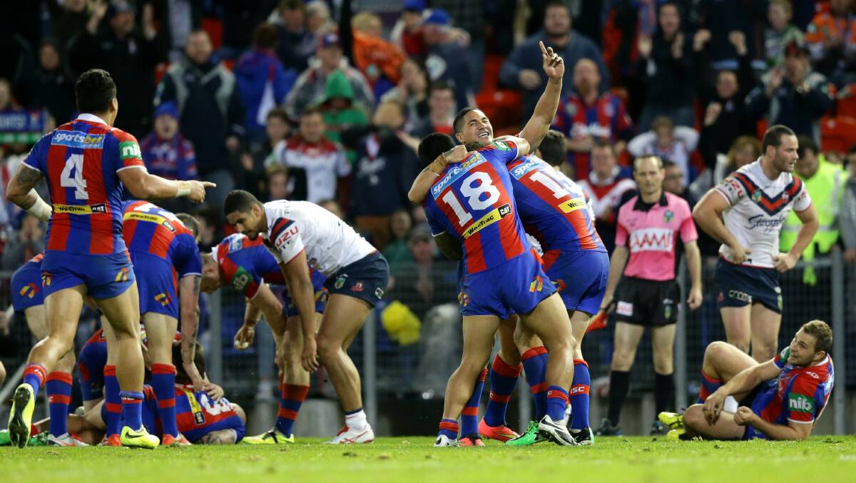 Newcastle Knights players celebrate their win over on Sydney Roosters at the full-time whistle. 