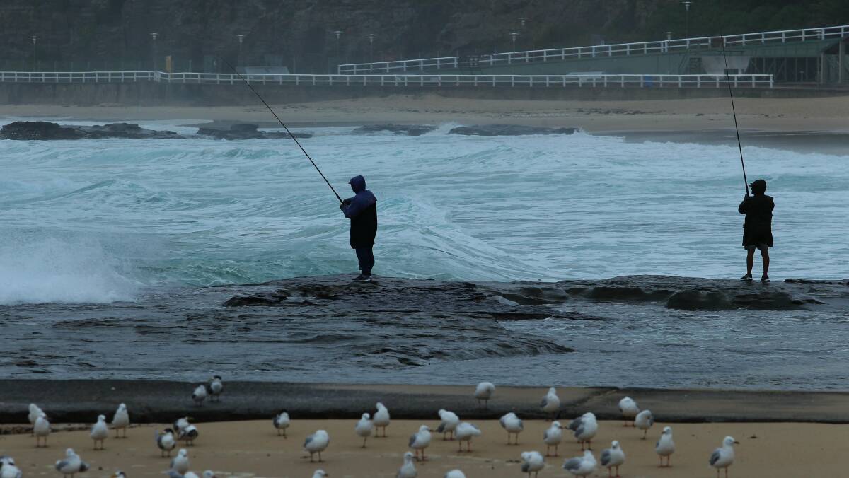 Fishermen on the rocks at Newcastle Beach.