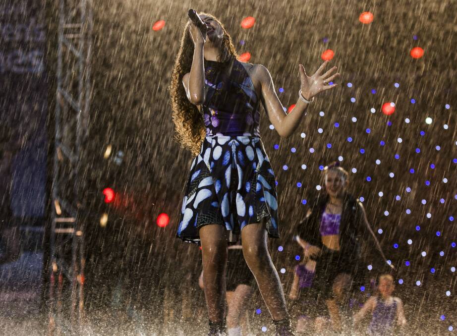 Hamilton teenager Mia Sifflet makes her words more meaningful as she sings Never Give Up in the rain. Picture by  Brenda Ashley.