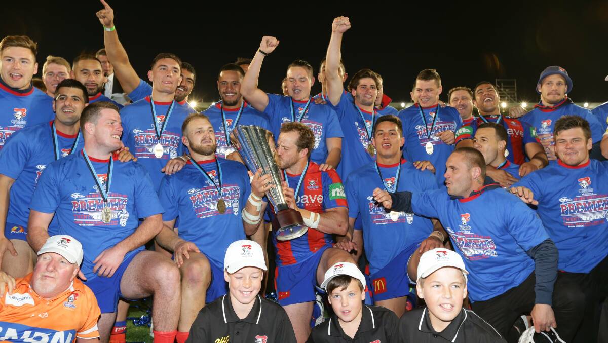 Knights captain Clint Newton kisses the NSW Cup as the team celebrates.   Picture: Jonathan Carroll