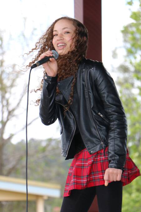 Mia Sifflet singing Never Give Up at Lake Macquarie International Children's Games torch relay at Speers Point Park in October.