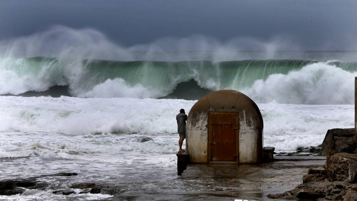 Ben Uttley from Newcastle West braves the rough weather to photograph waves off Newcastle baths lat month.