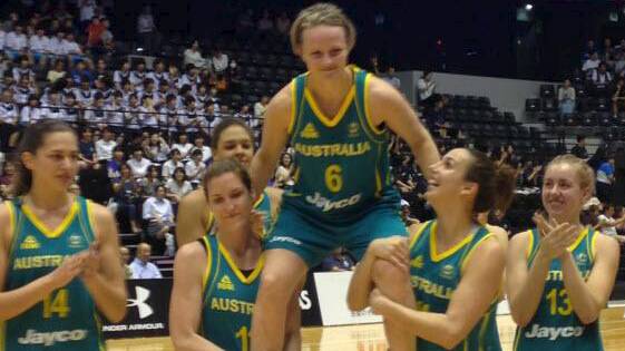 Opals basketballer Jennifer Screen is carried off the court after her last representative game by her teammates. 
