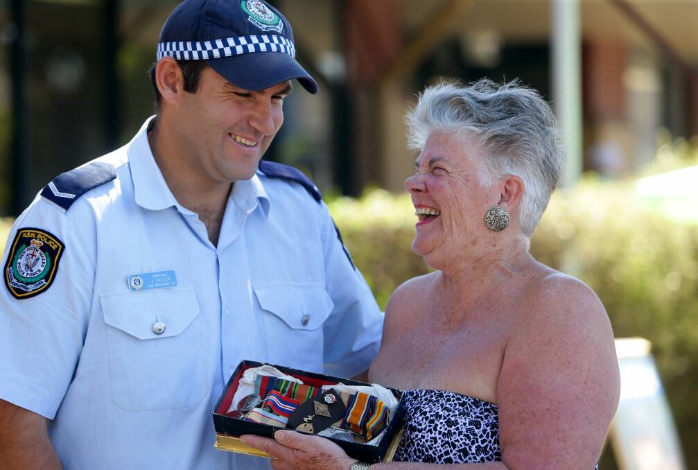 Constable Jamie Taylor with  Leslie Wiles and the returned war medals.
