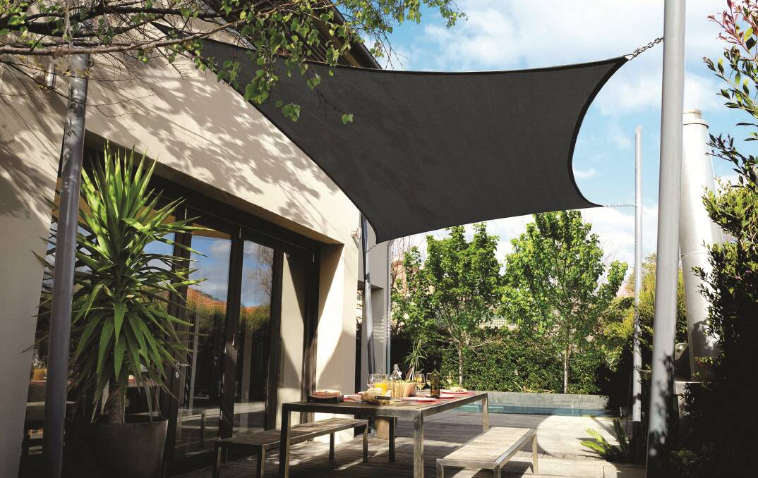 Comfy furniture and a shade sail help define the ultimate outdoor living space. Photo: SUPPLIED.