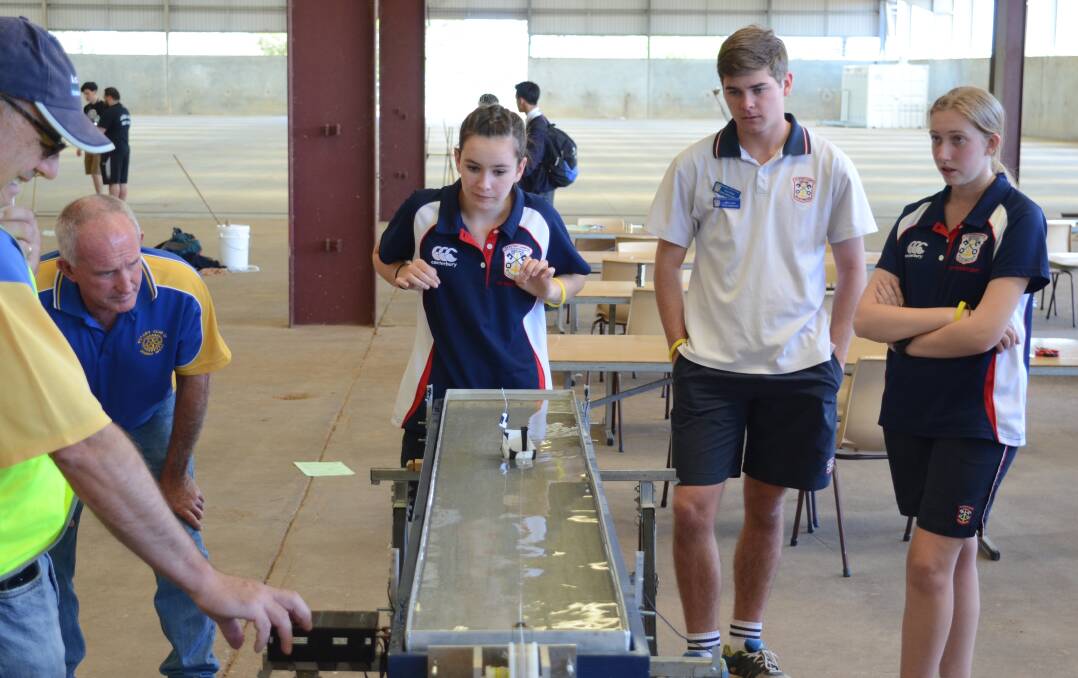 TEST RUN: ﻿Therese Hall, Harry Jordan, Hannah Levey and Angus Barnes from All Saints College St Peter's Campus, Maitland, watch as their boat is tested. Photo: Mark Rayner