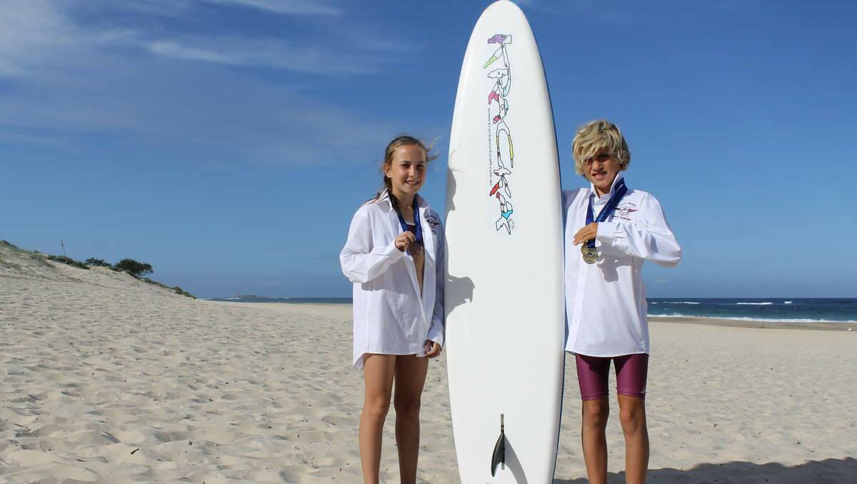 YOUNG STARS: Caves Beach Surf Life Saving Club’s Amy Gosling, 12, and Joel O’Callaghan, 10, with their medals from the NSW State Championships at Umina Beach.