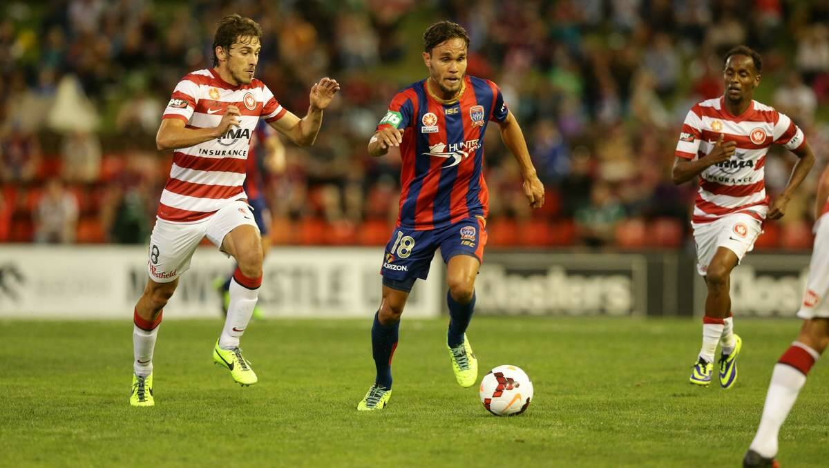 NOT FIRING: The Newcastle Jets try to retain the ball against the Western Sydney Wanderers.