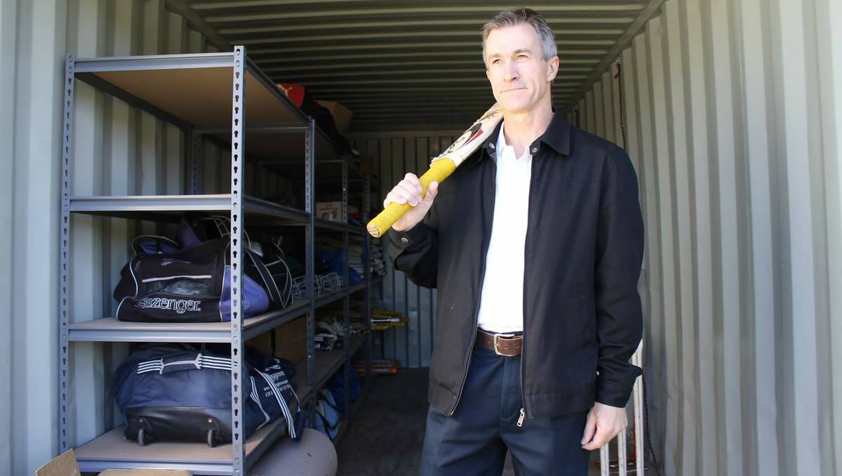 CRAMPED: Valentine-Eleebana Cricket Club President Greg Mahoney in one of the club's shipping containers.