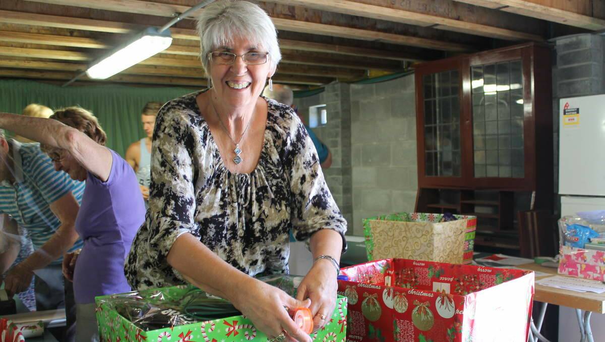 HELPERS: St Luke’s Uniting Church Community Commission volunteers pack hampers to distribute for Project Blessing. Volunteer Eldrene Stark, of Elermore Vale.