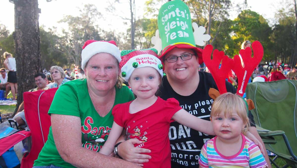 Margaret Kelvin of Wallsend with Mia Evans, 5, of Wallsend; Heidi Evans, of Wallsend and Dante Coxon, 2, of Lambton at Newcastle Permanent annual Carols By Candlelight, Speers Point Park.