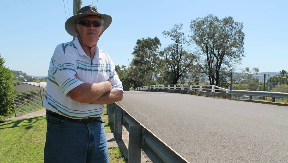 ONE WAY: Holmesville resident Bernard Griffin stands at the Teralba subdivision's only entry point, Pitt Street.