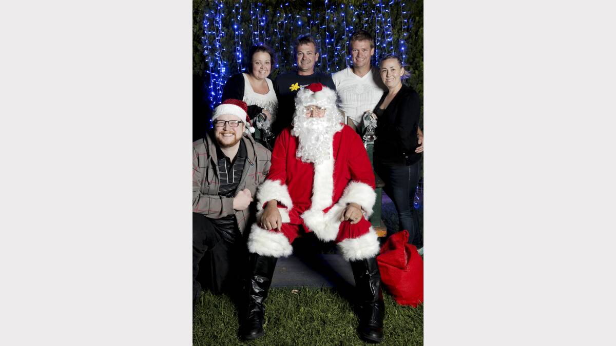 HAPPY CHRISTMAS: Peter, Melissa, Arren, Shane and Alexandra Bower with Santa. Picture: Living Light Photography.