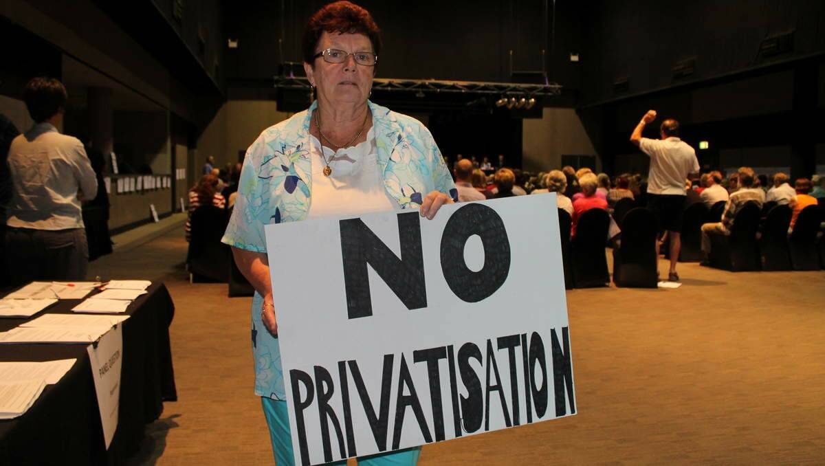 GUARDIAN: Mary Engelman, of Elermore Vale, holds a handmade sign at the community forum.